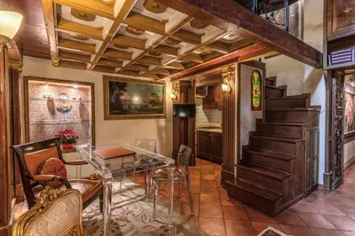 a living room with a staircase and a table at The Eleanor Secret Studio - Campo de' Fiori in Rome