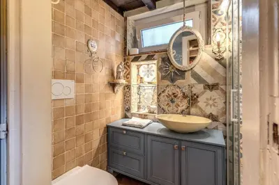 a bathroom with a sink and a mirror at The Eleanor Secret Studio - Campo de' Fiori in Rome
