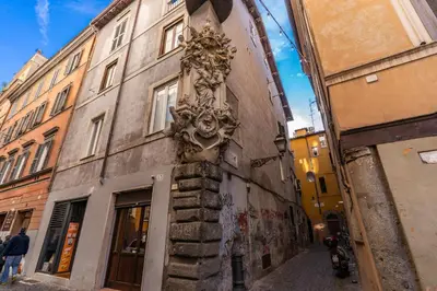 a mask on the side of a building at The Eleanor Secret Studio - Campo de' Fiori in Rome
