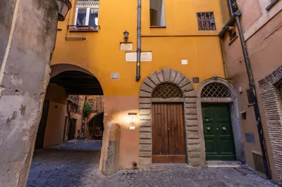 an alley with two doors in a building at The Eleanor Secret Studio - Campo de' Fiori in Rome