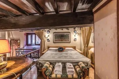 a bedroom with a bed and a table at The Eleanor Secret Studio - Campo de' Fiori in Rome