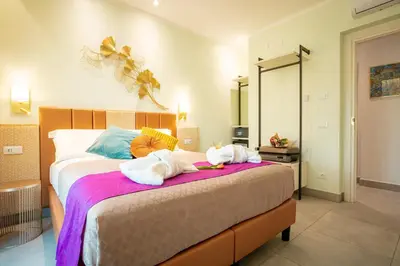 a bedroom with a bed with towels on it at Twins Royal Suite in Rome