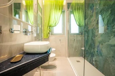 a bathroom with a sink and a shower at Twins Royal Suite in Rome