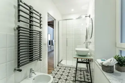 a white bathroom with a sink and a shower at Iflat Cozy Studio in the Heart of Campo de Fiori in Rome