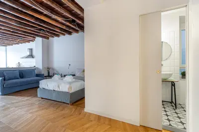 a bedroom with a bed and a blue couch at Iflat Cozy Studio in the Heart of Campo de Fiori in Rome
