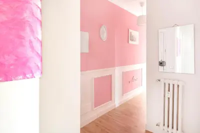 a room with pink walls and a hallway with a radiator at Luxury Pink apartment in Rome