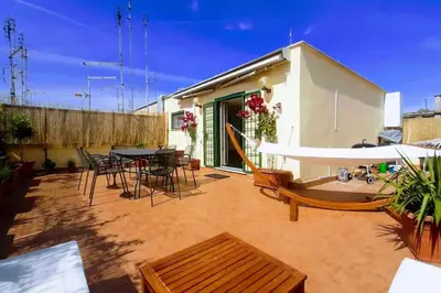 a patio with a table and chairs and a building at Amazing studio with terrace in Rome