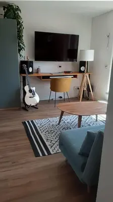 a living room with a tv and a couch and a guitar at Amazing studio with terrace in Rome
