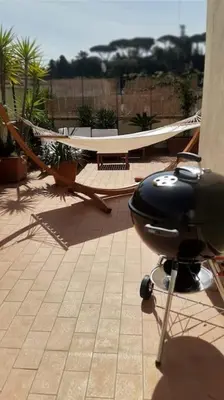a helicopter sitting on a patio with a hammock at Amazing studio with terrace in Rome