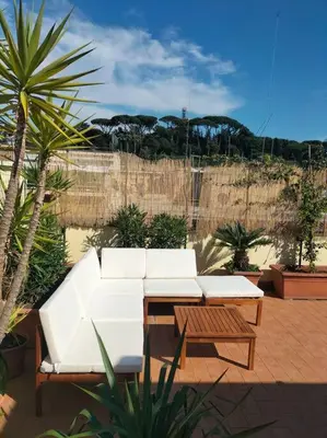 a white couch and a table on a patio at Amazing studio with terrace in Rome