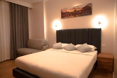 a bedroom with a large bed and a chair at Vatican Bliss in Rome