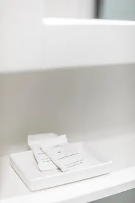 a white shelf with two books on a table at Casina Bianca in Rome