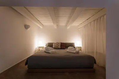 a bedroom with a bed with two towels on it at Casina Bianca in Rome