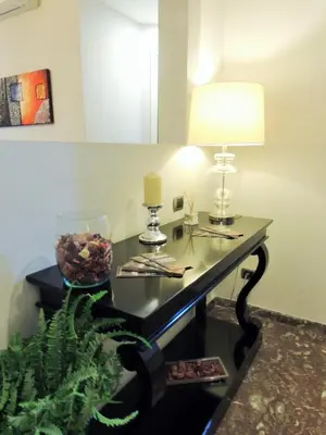 a room with a table with a lamp and a plant at Florida rooms - comfort Hotel in Rome
