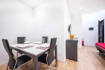 a dining room with a table and four chairs at Anna Vatican Loft - Relax al centro di Roma! in Rome