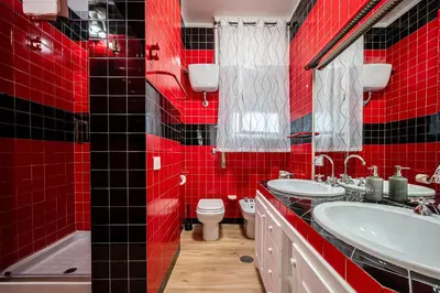 a red bathroom with two sinks and a toilet at Anna Vatican Loft - Relax al centro di Roma! in Rome