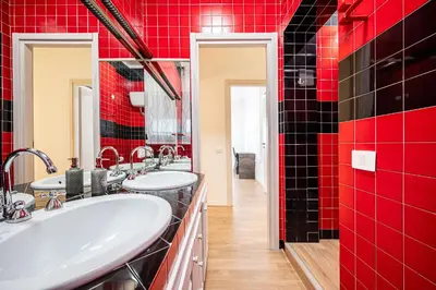 a bathroom with two sinks and red tiles at Anna Vatican Loft - Relax al centro di Roma! in Rome