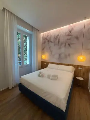 a bedroom with a large bed with two towels on it at Rome Riverside Retreat in Rome