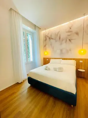 a bedroom with a large white bed with two lamps at Rome Riverside Retreat in Rome