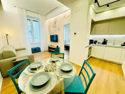 a dining room with a glass table and chairs at Rome Riverside Retreat in Rome