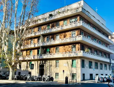 a building with motorcycles parked in front of it at Rome Riverside Retreat in Rome