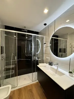 a bathroom with a shower and a sink and a mirror at Rome Riverside Retreat in Rome