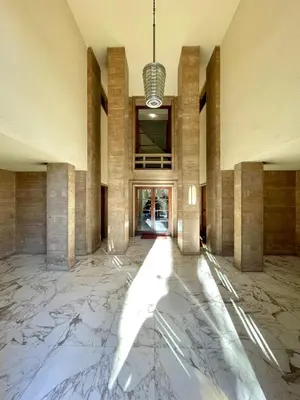 a large lobby with marble floors and a chandelier at Rome Riverside Retreat in Rome