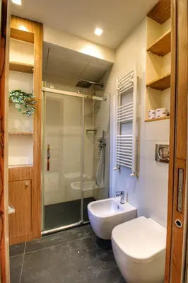 a bathroom with a shower and a toilet and a sink at Domus Mazzini in Rome