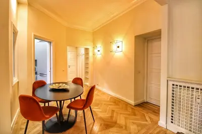 a dining room with a black table and orange chairs at Domus Mazzini in Rome