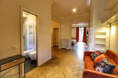 a living room with a couch and a bathroom at Domus Mazzini in Rome