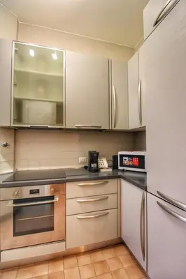 a kitchen with stainless steel appliances and white cabinets at Domus Mazzini in Rome