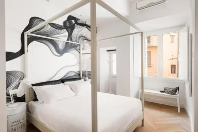 a bedroom with a white bed with a metal canopy at Iflat New Spacious & Classy Apartment in Monti in Rome
