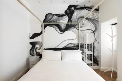 a bedroom with a bed with a black and white wall at Iflat New Spacious & Classy Apartment in Monti in Rome