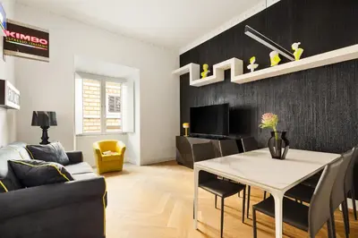 a living room with a table and a dining room at Iflat New Spacious & Classy Apartment in Monti in Rome
