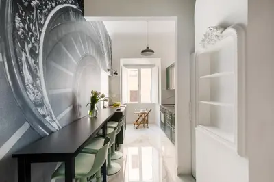 a dining room with a black table and green chairs at Iflat New Spacious & Classy Apartment in Monti in Rome