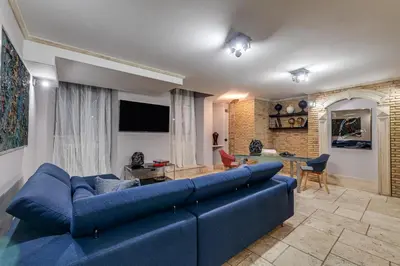 a living room with a blue couch and a table at Oliviero - Piazza Navona Apartment in Rome