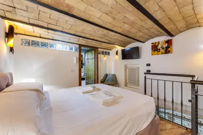 a bedroom with a bed and a tv on the wall at Oliviero - Piazza Navona Apartment in Rome