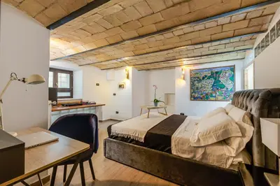 a bedroom with a bed and a desk with a computer at Oliviero - Piazza Navona Apartment in Rome