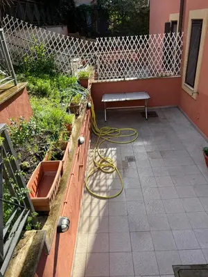 a patio with a bench and a garden at Domus del Vicario in Rome