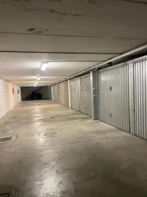 an empty hallway of an empty parking garage at Domus del Vicario in Rome