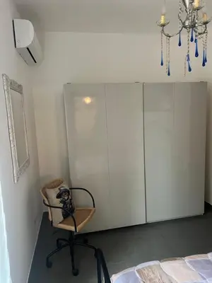a dog sitting in a chair in a bedroom at Domus del Vicario in Rome