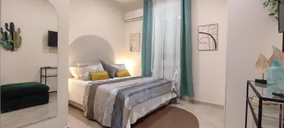 two pictures of a bedroom with a bed and a mirror at Roma Brancaleone Loft, Metro C in Rome