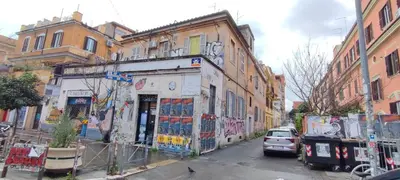 a building with graffiti on it on a city street at Roma Brancaleone Loft, Metro C in Rome
