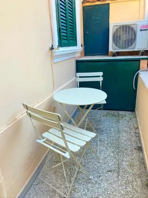 a table and a chair sitting next to a counter at Roma Brancaleone Loft, Metro C in Rome
