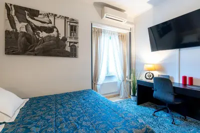 a bedroom with a bed and a desk and a computer at NEW Luxury-On-Budget in Rome