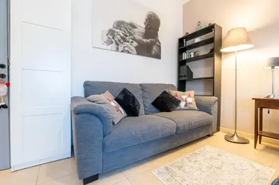 a living room with a blue couch with pillows at NEW Luxury-On-Budget in Rome
