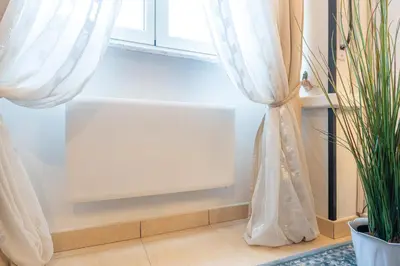 a window with a white curtain next to a plant at NEW Luxury-On-Budget in Rome