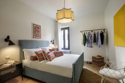 a bedroom with a bed with pillows on it at Tiberim Lux Penthouse City View in Rome