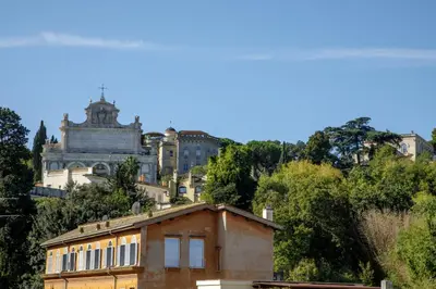 an old house on a hill with a building at Tiberim Lux Penthouse City View in Rome