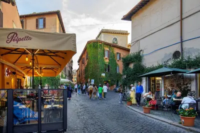 a group of people walking down a street with buildings at Tiberim Lux Penthouse City View in Rome
